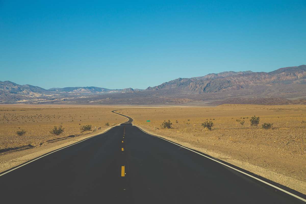 death valley asphalt road towards mountain highway
